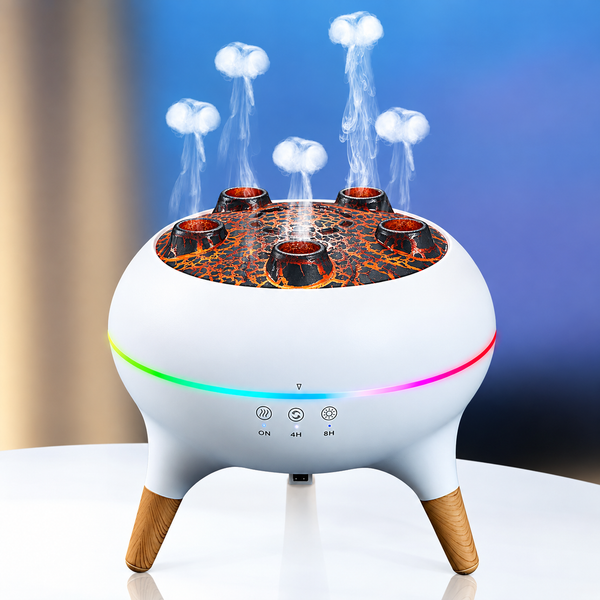 A modern spherical tabletop diffuser or humidifier with three wooden legs, featuring a white body, a glowing multicolor LED ring, and a lava-patterned top with three candle holders. Steam is shown rising from the top, set against a blue gradient background.